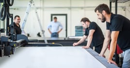 Professional workers graphic technicians operators work in a printing press and print shop with many different types of machines