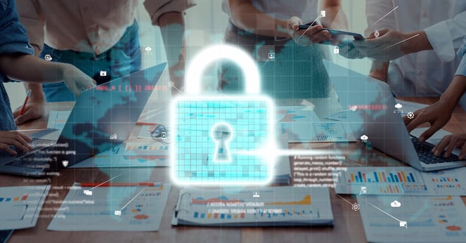 A collaborative team analyzing data security in an office setting, surrounded by laptops and digital elements representing cybersecurity concepts and data protection.