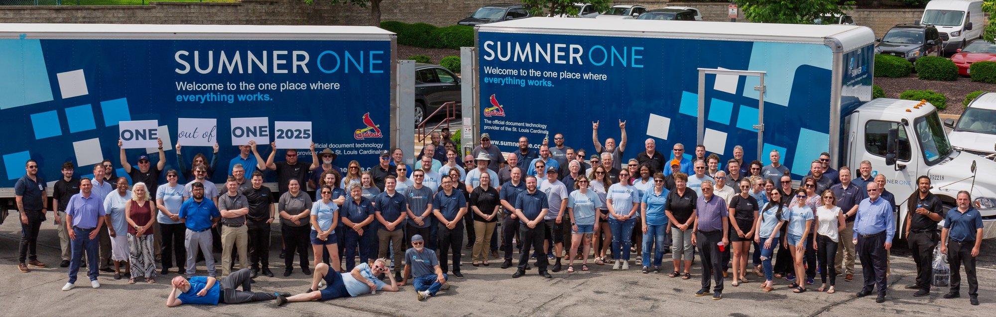 SumnerOne staff outside the office with company trucks.