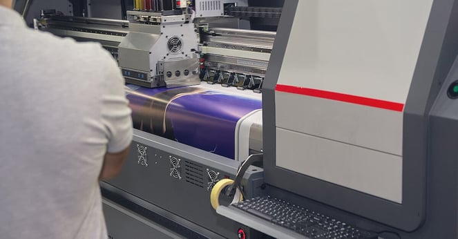 Modern printing machine and worker near it. industry