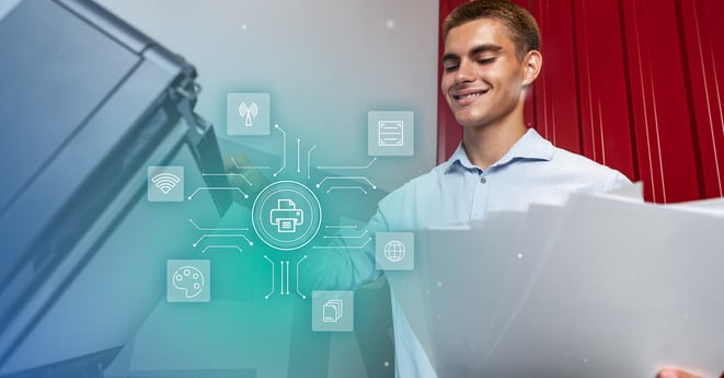 Young man using a printer in a modern office setting while managing documents and printing tasks