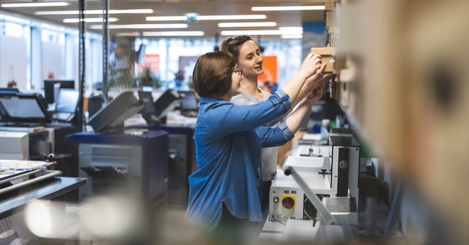 Professional female employees working in a printing house