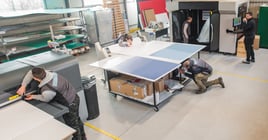 Large group of worker printmaker technician operator works in digital printing press hall and printshop office with many different type of machine.