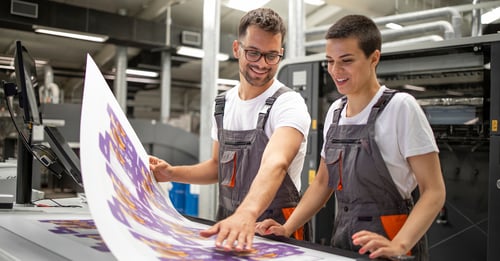 commercial print shop staff admiring the product of their specialty printing services