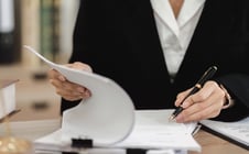 Professional Female Lawyer Reviewing Contract Documents for Legal Case in Office Setting
