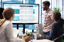 Company workers in a high end office space collaborating on project management tasks, utilizing digital tools to enhance workflow and productivity. Reviewing big data on interactive board.