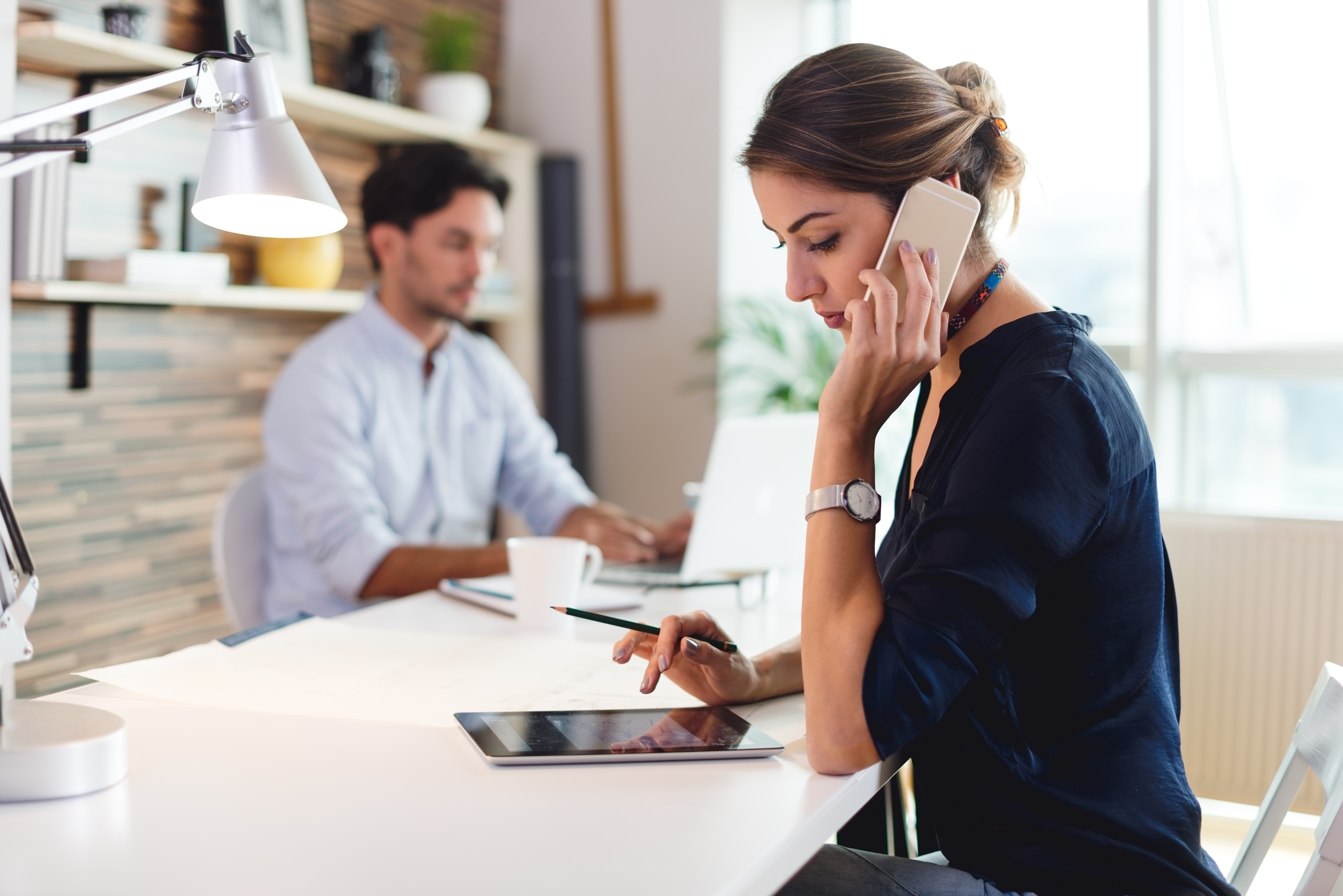 woman speaking on mobile phone and tablet