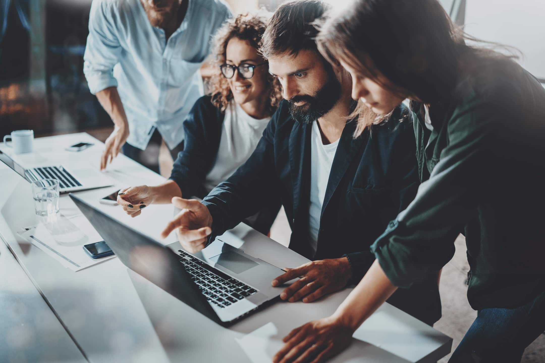 Employeees-collaborating-around-a-computer-effectively