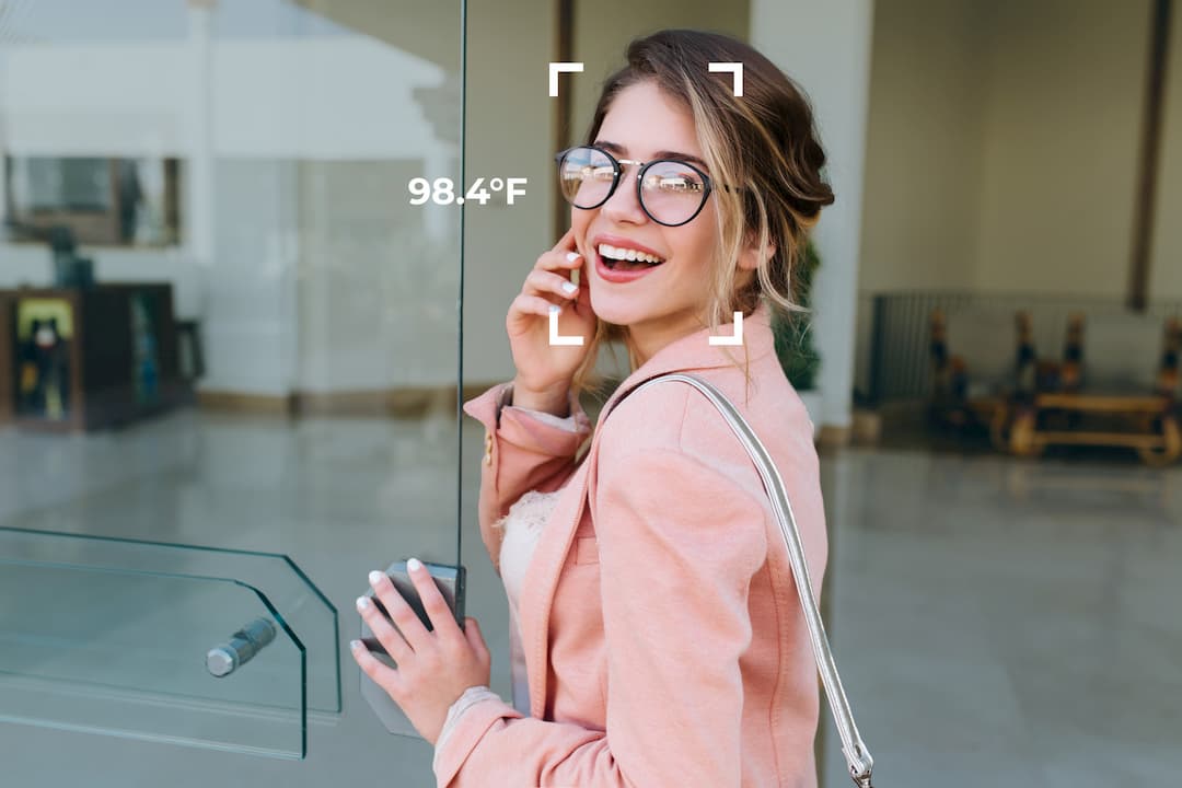 Woman-entering-a-building-getting-her-temperature-checked