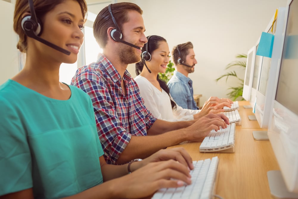 Business team working together at a call centre wearing headsets-1