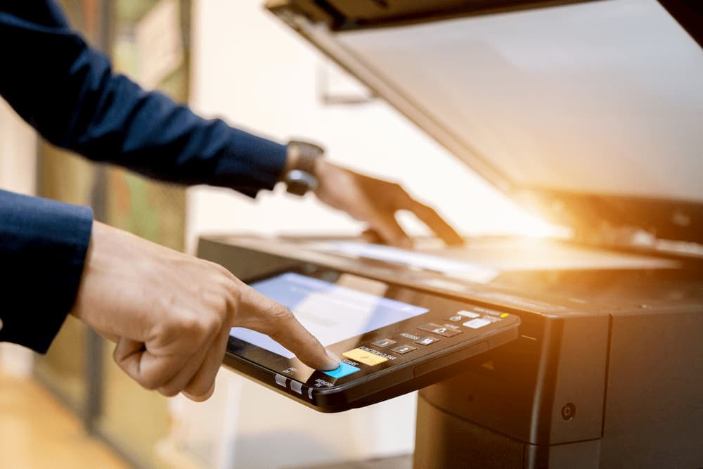 close up of man using a copier