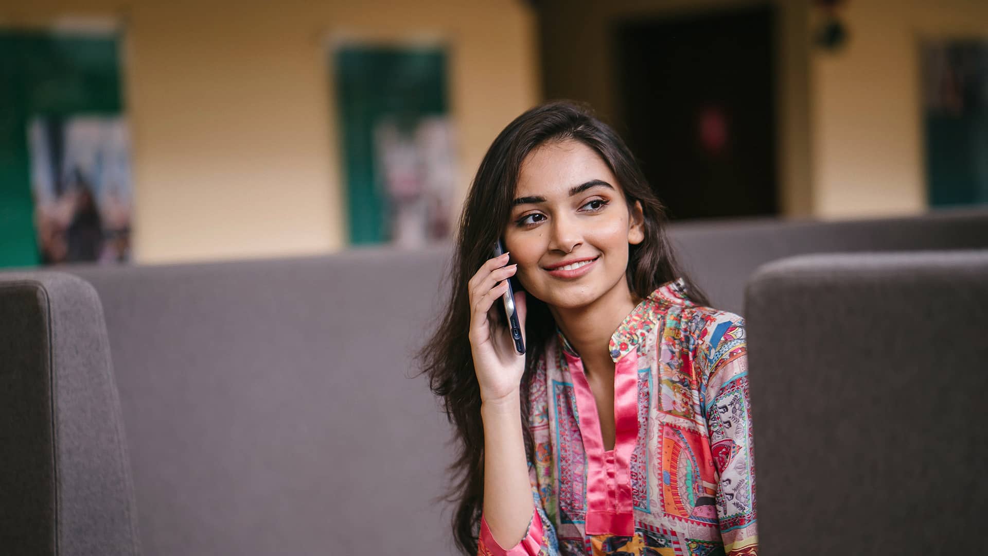 woman-speaking-on-cellphone-in-a-call-center